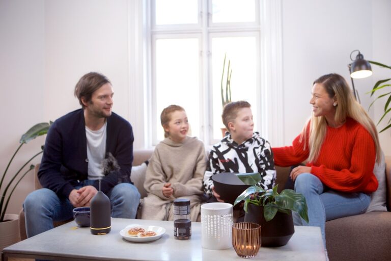 Two people sitting together indoors, one offering support while the other listens quietly.